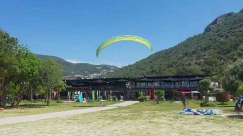 Paraglider and passenger make a smooth landing. Stock Footage 312441119
