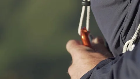 Paraglider attaching the harness to a hook Stock Footage 76003184