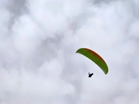 Paraglider on cloudy sky background Stock Photos