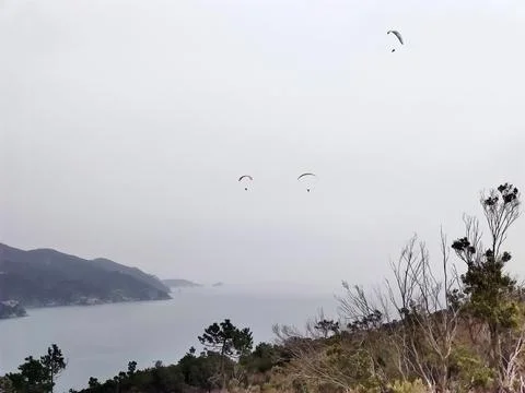 Paraglider on cloudy sky backgroundi n monterosso cinque terre italy Stock Photos