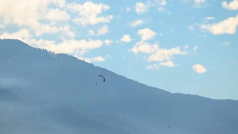 Paraglider doing stunts with parachute in front of the mountains at Manali  Stock Footage 188434199
