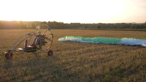 The paraglider is on the field during sunset Video stock 94400620