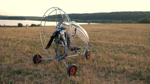 The paraglider is on the field during sunset Video stock 94400683