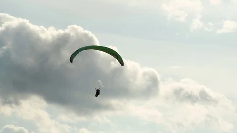 The paraglider flies on a background of a cloudy sky Stock Footage 84549149