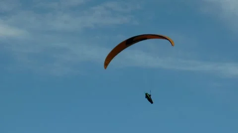 Paraglider flies in the blue cloudless sky. Stock Footage 68725596