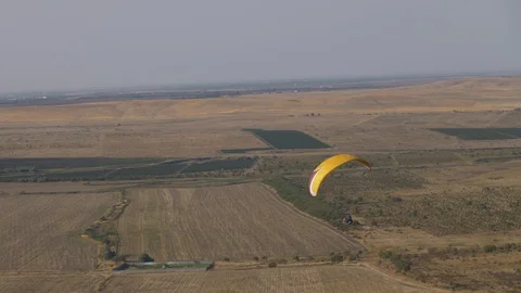 Paraglider flight over fields in summer Stock-Footage 118881740