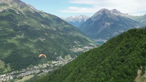 Paraglider floating above Eau d'Olle valley in Alpe d' Huez, French Alps - Video stock 221885619