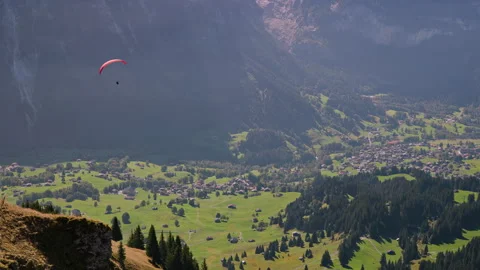 Paraglider floating through the sky over Zermatt, Switzerland Stock Footage 255415892