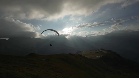 Paraglider flying against the cloudy sky on a sunny day Stock Footage 76003933