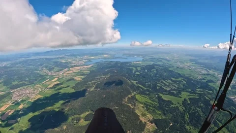 Paraglider flying high above forest mountains, adrenaline adventure freedom Stock Footage 276163755