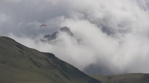 Paraglider flying high in the clouds Video stock 63371159