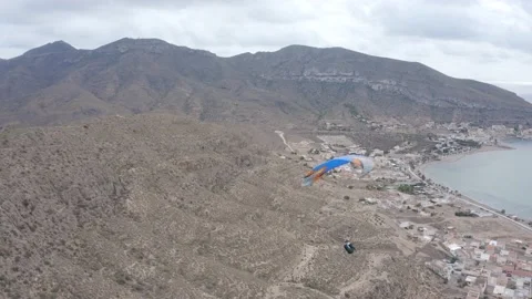 Paraglider flying over the beach of  La Azohia,Province of Murcia, Spain Stock Footage 164239088