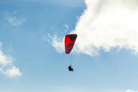 Paraglider flying over clouds in summer day Stock Photos