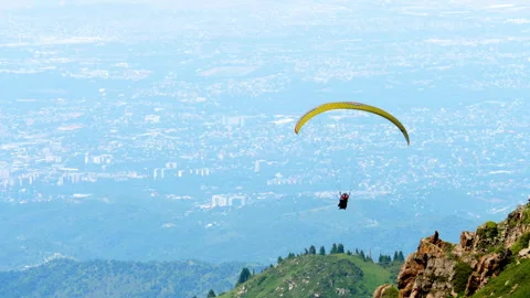 Paraglider flying over mountains Stock Footage 323006734
