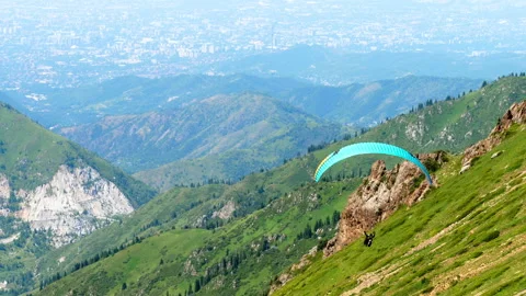 Paraglider flying over mountains Stock Footage 323394325