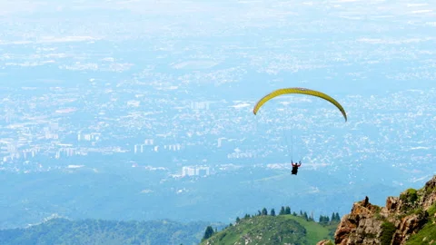 Paraglider flying over mountains Stock Footage 323764871