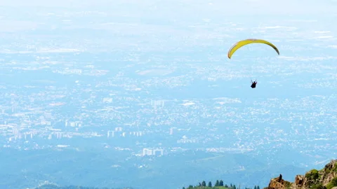 Paraglider flying over mountains Stock Footage 325422109