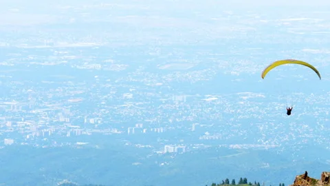 Paraglider flying over mountains Stock Footage 332962277