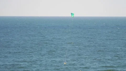 Paraglider flying over the ocean on a clear day in 4K slow motion 60fps Video stock 286421536