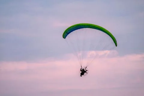 Paraglider flying with paramotor during sunset Foto stock