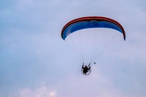 Paraglider flying with paramotor during sunset Foto stock