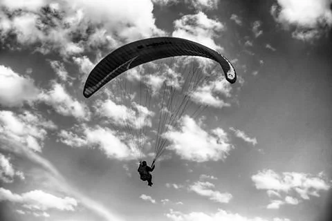Paraglider flying in the sky Stock Photos