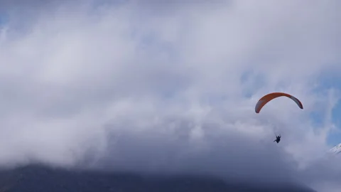 Paraglider flying through the clouds Stock Footage 171988988