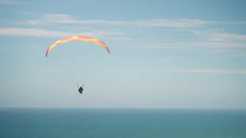 Paraglider flys out over the Pasific Stock Footage 201887791