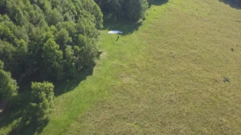 Paraglider getting ready to fly. Drone flying above the paraglider. Stock Footage 261502873