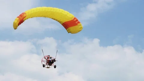 A paraglider glides through the sky. Stock Footage 163314915