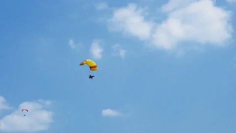 A paraglider glides through the sky. Stock Footage 163315032
