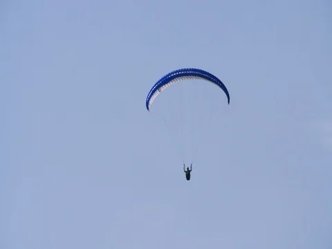 Paraglider gliding in the sky of Austria Stock Footage 79567227