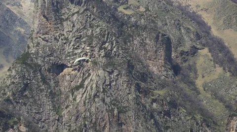 Paraglider goes down on the background of rocks Video stock 63371344
