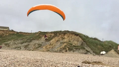 Paraglider landing on the beach Stock Footage 105596745