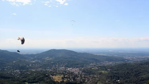 Paraglider from left to right of frame over Merkur, Germany Stock Footage 125880966