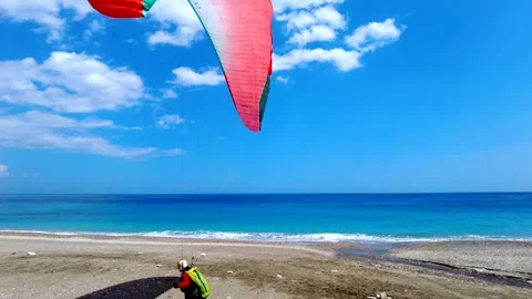 Paraglider Makes A Perfect Landing On The Beach In Italy Stock Footage 242513023