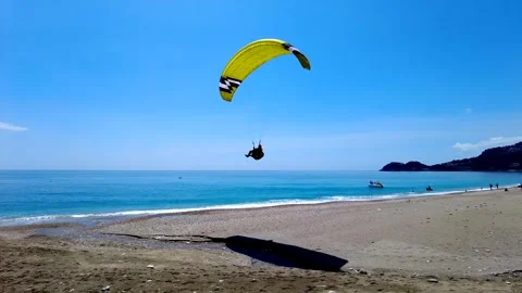 Paraglider Makes A Perfect Landing On The Beach In Italy Stock Footage 242513030