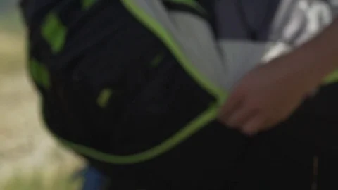 Paraglider opening his hiking backpack Stock-Footage 76003322