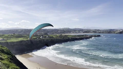 Paraglider Over Beach and Ocean - Cliffside View in Cantabria, Spain Video stock 304322031