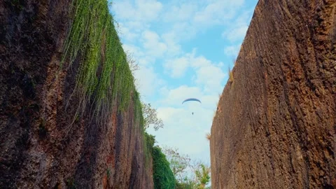 Paraglider Over a Narrow Canyon Stock Footage 293314364