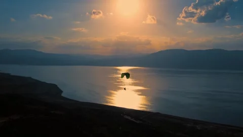 Paraglider Over Ocean at Dusk Stock Footage 310751949