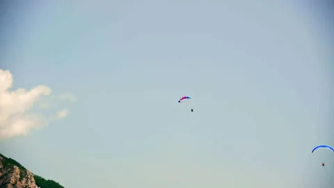 Paraglider performing acrobatic tricks, spirals, and twists high in the sky. Video stock 302881146