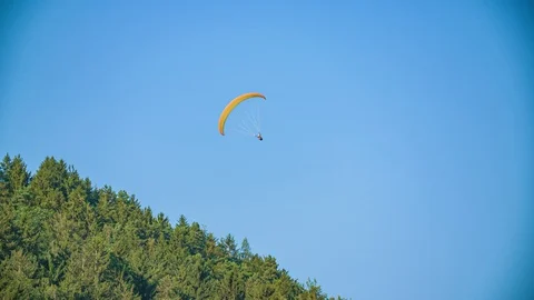 Paraglider pilot do acrobatic manoeuvres enjoy freedom, blue sky. Extreme Stock Footage 129671854