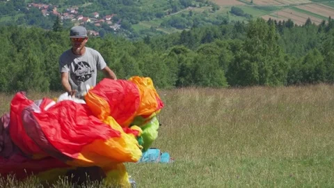 Paraglider Pilot Drops Canopy and Spreads Wires Stock Footage 304676226