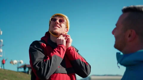 Paraglider is preparing for flight, putting on helmet. Video stock 201686819