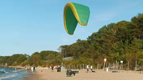Paraglider is preparing to take off on a sandy beach in summer Stock Footage 266356722