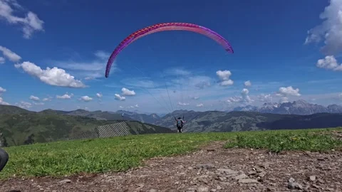 Paraglider preparing for takeoff in the mountains on a sunny day. 動画素材 343101908