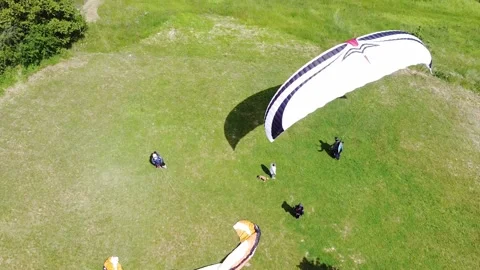 Paraglider ready to fly - Back view of paraglider about to leave the ground Видео 130829107