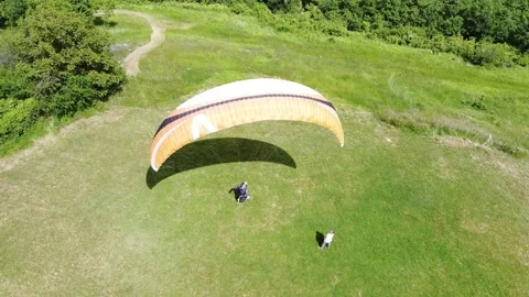 Paraglider ready to fly - Back view of paraglider about to leave the ground Stock Footage 130830127