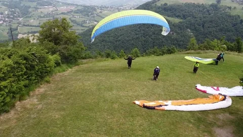 Paraglider ready to fly - Back view of paraglider about to leave the ground Video stock 130880602